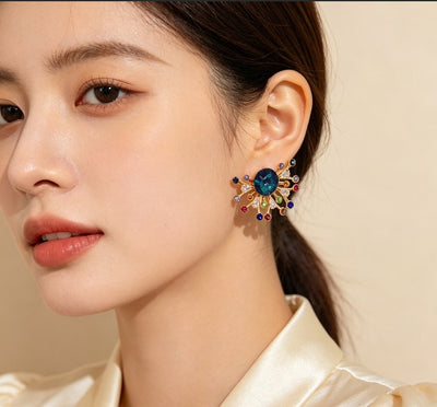 Unique Fireworks Shaped Design, Centered With A Deep Teal Blue Crystal, Surrounded By Bright Multi Color Tiny Zircons, Eye Catching And Gorgeous.